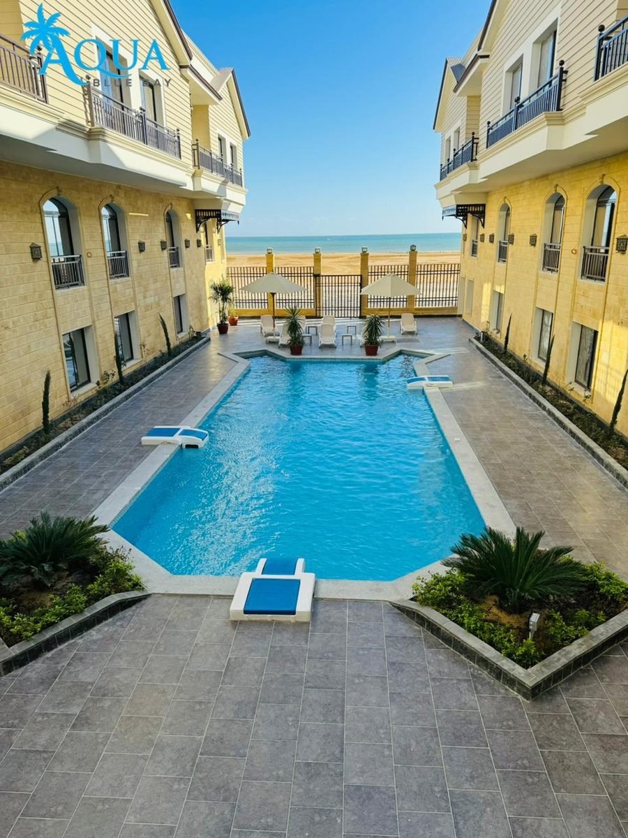 Aqua Blue Bay — the pool between the blocks, with the sea beyond