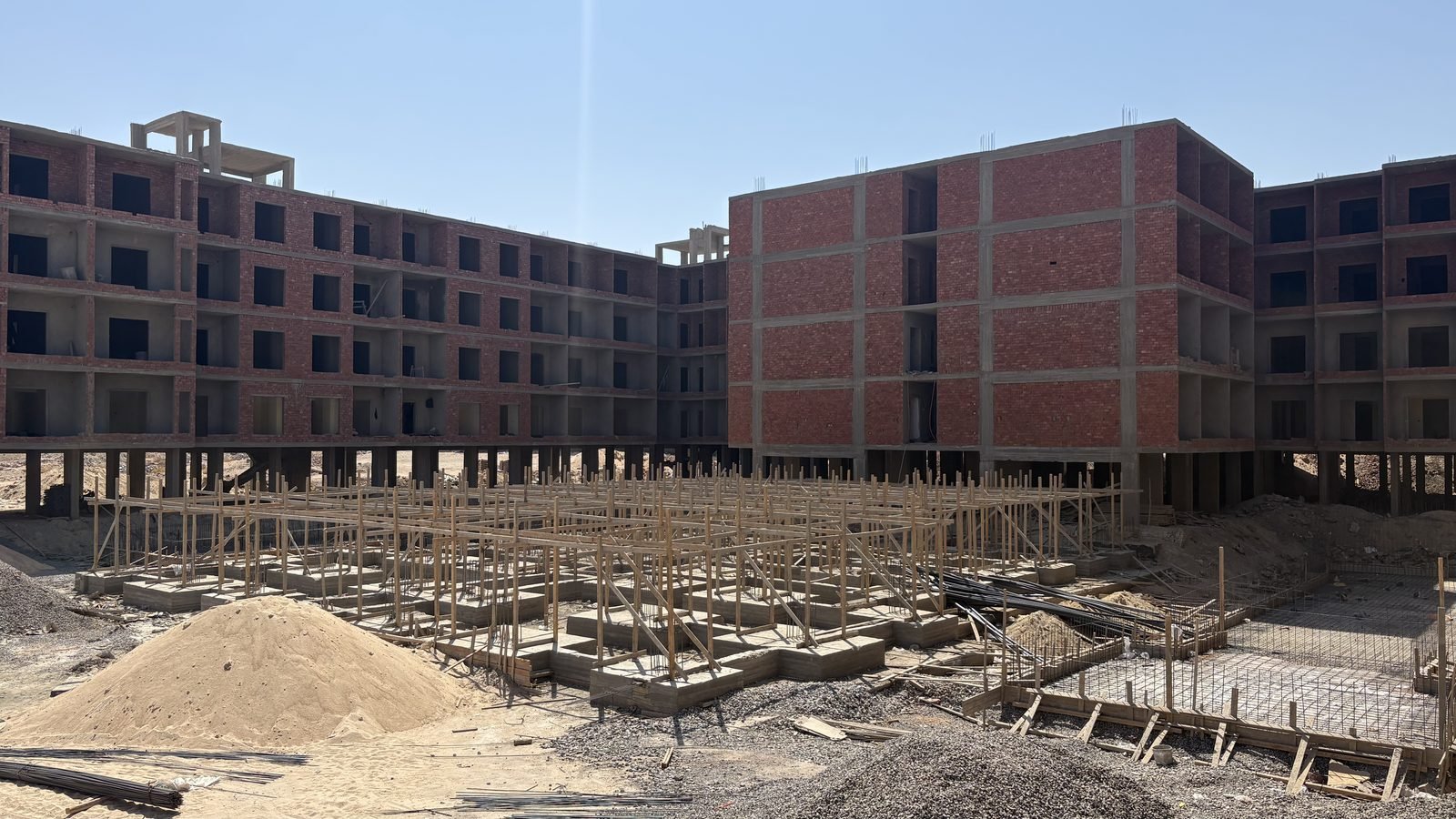 AQUA ORGWAN Resort under construction in Hurghada &mdash; the blocks in structure, with the pool foundations in the foreground