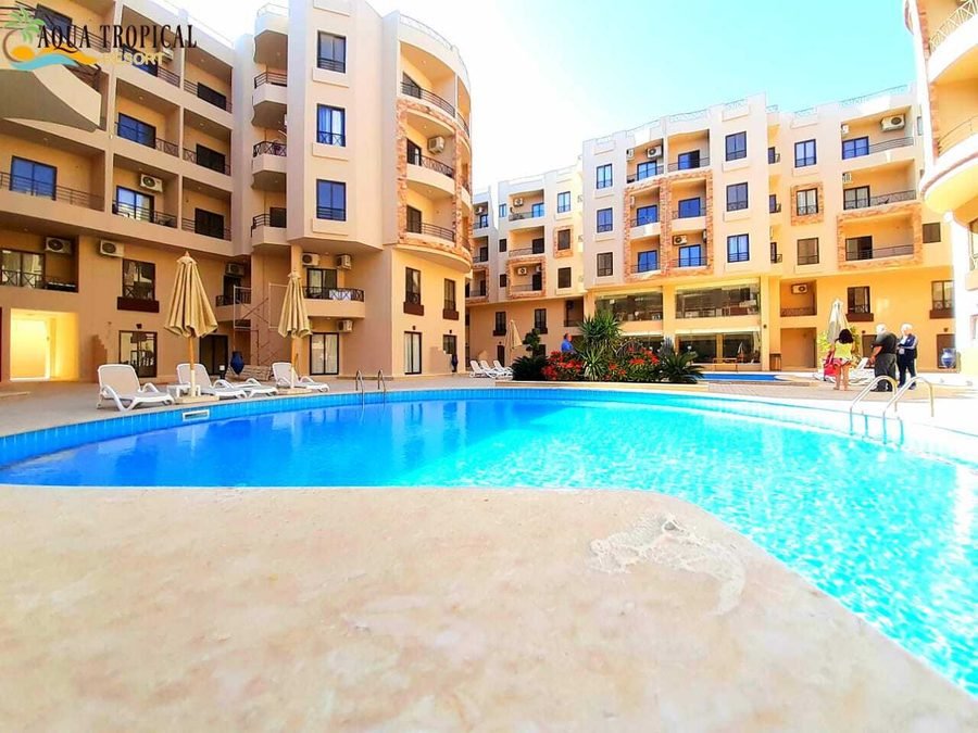 Aqua Tropical Resort — poolside loungers and umbrellas
