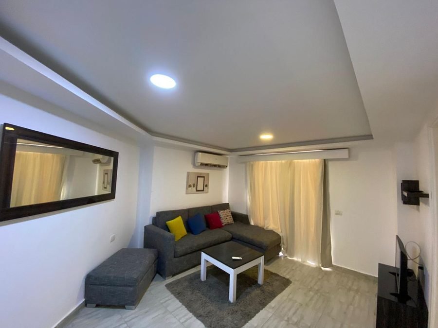 Penthouse at Aqua Palms — living area with sofa and television