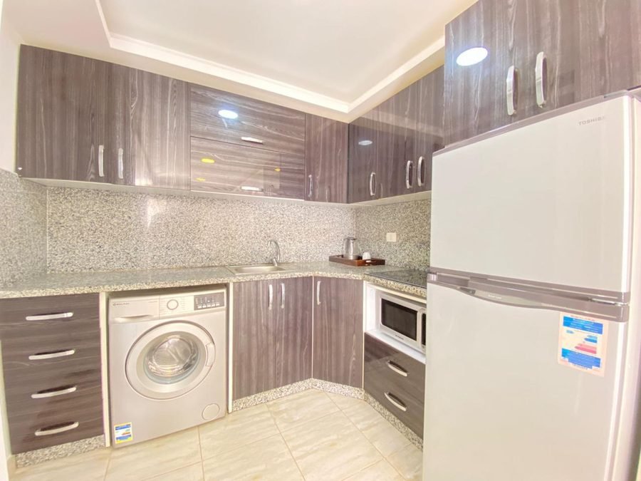 Penthouse at Aqua Palms — kitchen with washing machine