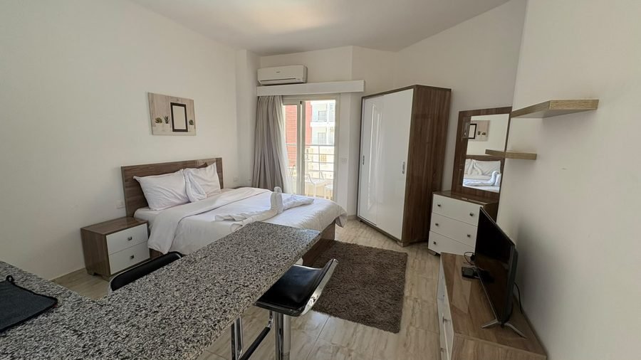 Studio at Aqua Palms — bed, wardrobe and television