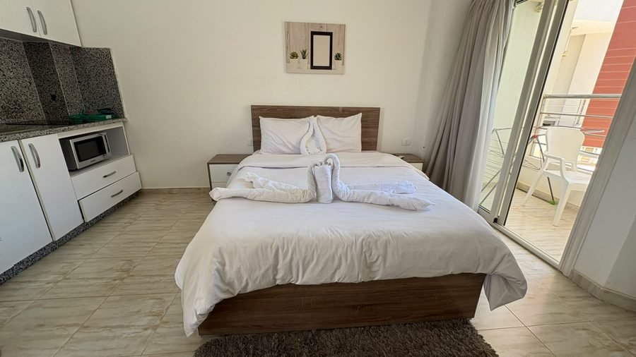 Studio at Aqua Palms — bed beside the balcony door